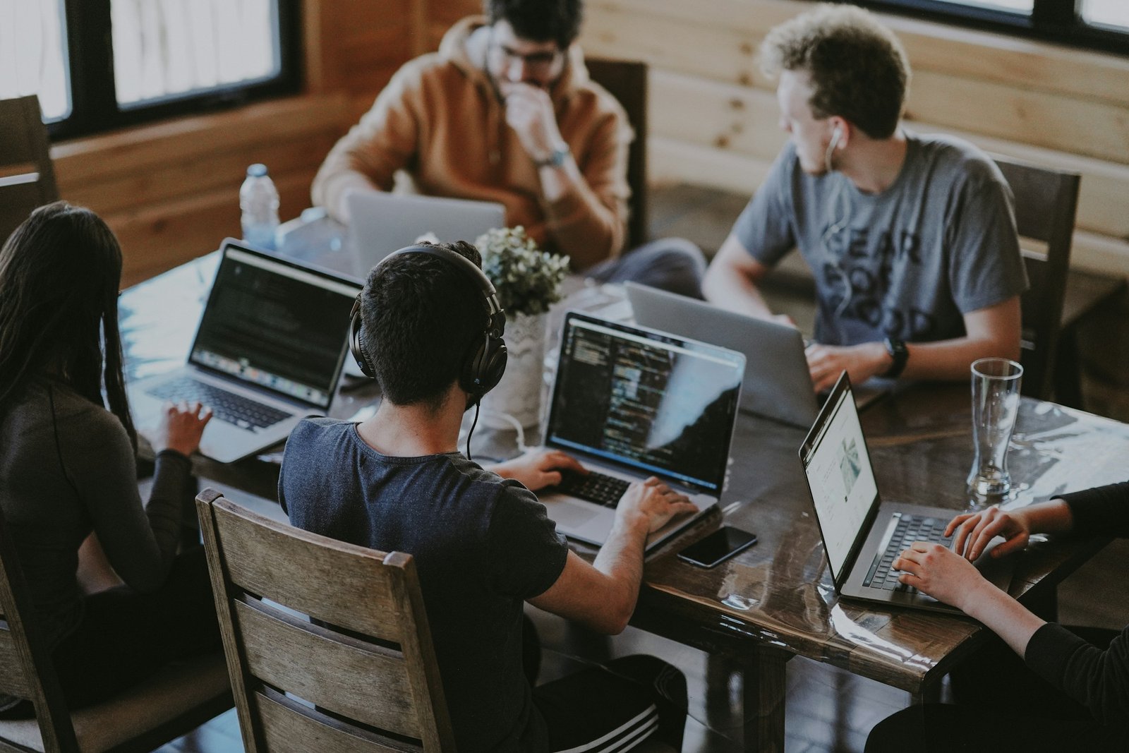 A diverse team sharing ideas and working together in a bright creative workspace